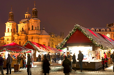 Snow-covered Christmas Market and Baroque St. Nicholas Church, Old Town Square, Prague, Czech Republic, Europe 