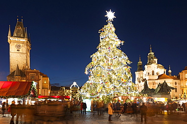 Christmas Market at Old Town Square with Gothic Old Town Hall, Jan Hus Monument and Baroque Church of St. Nicholas at twilight, Old Town, UNESCO World Heritage Site, Prague, Czech Republic, Europe