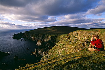 Birdwatching on the cliffs at Hermaness National Nature Reserve in June, Unst, Shetland, Scotland, United Kingdom, Europe