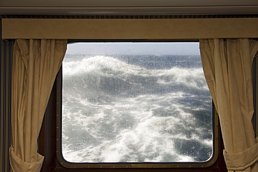 View from cabin on Antarctic Dream navigation on rough seas near Cape Horn, Drake Passage, Antarctic Ocean, Tierra del Fuego, Patagonia, Chile, South America