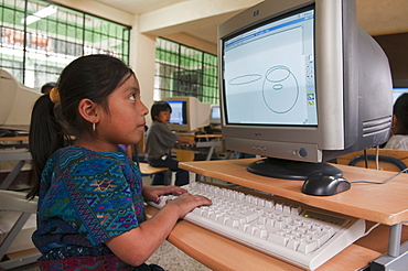 Working on PC at Santa Catarina Palopo primary school, Lake Atitlan, Guatemala, Central America