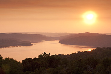 View of sunset over Lake Yaxha from Temple 216, Yaxha, Guatemala, Central America