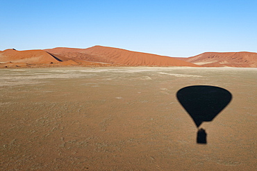 Hot air balloon shadow on desert, Namib Naukluft Park, Namib Desert, Namibia, Africa