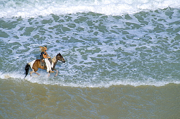 Woman riding horse on the beach, Tibau do Sul, Natal, Rio Grande do Norte state, Brazil, South America