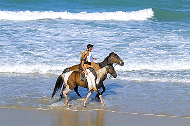 Couple riding horses on the beach, Tibau do Sul, Natal, Rio Grande do Norte state, Brazil, South America