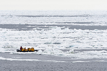 Tourists on inflatable boats exploring the Polar Ice Cap, 81 degrees, north of Spitsbergen, Svalbard, Arctic, Norway, Europe