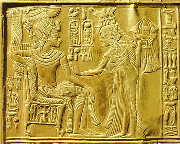 Detail of the exterior of the gilt shrine showing the queen bringing unguents and flowers to the king, from the tomb of the pharaoh Tutankhamun, discovered in the Valley of the Kings, Thebes, Egypt, North Africa, Africa