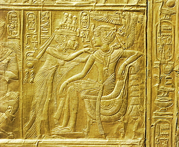 Detail of the exterior of the gilt shrine showing the queen fastening a necklace around the king's neck, from the tomb of the pharaoh Tutankhamun, discovered in the Valley of the Kings, Thebes, Egypt, North Africa, Africa