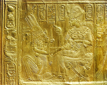 Detail of the exterior of the gilt shrine showing the king pouring perfumed liquid into the queen's hand, from the tomb of the pharaoh Tutankhamun, discovered in the Valley of the Kings, Thebes, Egypt, North Africa, Africa
