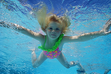 Young girl swimming underwater