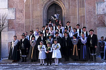 A peasant wedding, Guests posing in front of the church, Castelrotto, Trentino Alto Adige, Italy.