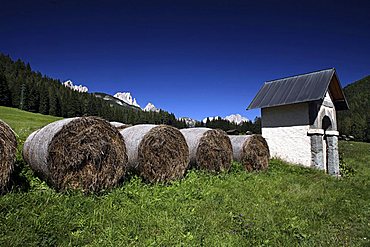 Hayballs and aedicula, Fassa Valley, Trentino, Italy