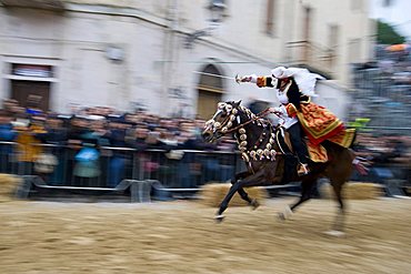 amazone Horseman gallops to pierce the star with his sword, Sartiglia feast, Oristano, Sardinia, Italy, Europe