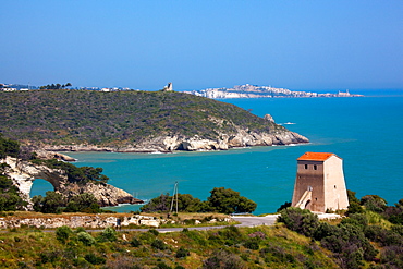 San Felice tower and on the backgrount the Architiello rock, San Felice Bay, coast between Mattinata and Vieste, Gargano Promontory, Gargano National Park, Puglia, Italy