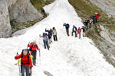 snowfield and hikers, arera mountain, italy