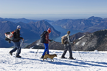 people with snowshoes, pora mountain, italy