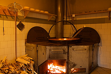 milk processing with hearth at pasture Arno`, Breguzzo valley, Adamello Brenta Natural Park, Giudicarie valley, Trentino, Italy