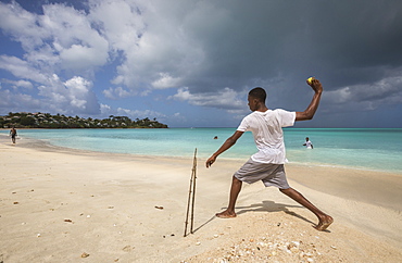 Kids playing on the beach surrounded by the turquoise Caribbean sea The Nest, Antigua and Barbuda, Leeward Islands, West Indies