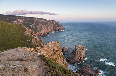 Ocean waves crashing on the cliffs of the Cabo da Roca cape at sunset, Sintra, Portugal, Europe