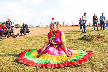 Chinese girl in traditional Chinese clothing during the Heqing Qifeng Pear Flower festival, China