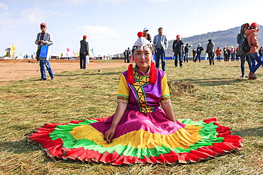 Chinese girl in traditional Chinese clothing during the Heqing Qifeng Pear Flower festival, China