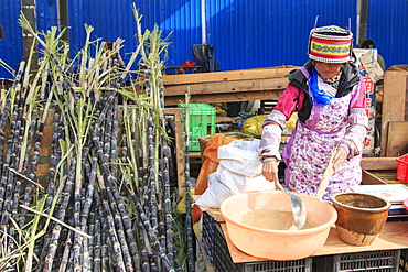 People selling and buying in a traditional market in the center of Kunming, China