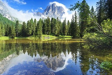 The lake Bai de Dones reflects with Tofana di Rozes sorrunded by clouds, Falzarego Pass, Veneto, Italy, Europe