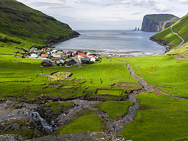 Village Tjornuvik. In the background the island Eysturoy with the iconic sea stacks Risin and Kellingin, North Atlantic.  Europe, Northern Europe, Denmark, Faroe Islands