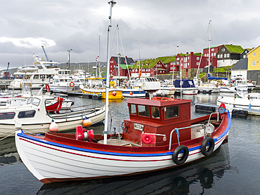 Peninsula Tinganes with old town and the red houses of the government district. Torshavn (Thorshavn) the capital of the Faroe Islands on the island of Streymoy in the North Atlantic, Denmark, Northern Europe