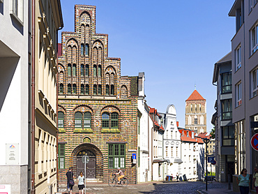 The Kerkhoffhaus buildt in the middle ages, church Nikolaikirche in the background. The hanseatic city of Rostock at the coast of the german baltic sea.  Europe,Germany, Mecklenburg-Western Pomerania, June