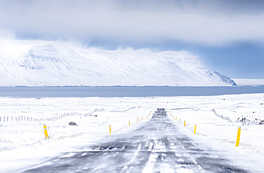 Landscape in Skagafjoerdur during winter. view of a snowed in country road with the fjord in the background  europe, northern europe, iceland,  March