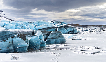 Svinafellsjoekull glacier in Vatnajoekull NP during Winter, view over the frozen glacial lake and the melting glacial front. europe, northern europe, scandinavia, iceland,  February