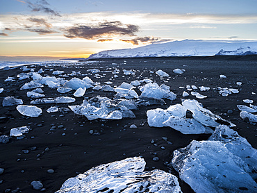 Iceberg on black vulcanic beach. North Atlantic beach of the ice lagoon Joekulsarlon at glacier Breithamerkurjoekull, Vatnajoekull NP. europe, northern europe, iceland, march