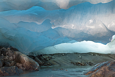 Ice cave and glacier snout of Schlatenkees, source of the creek Schlatenbach. parts of the have collapsed and melted away. Therefore an ice cave with two openings exists. The Schlatenkees is one of the biggest glaciers in Austria and retreating rapidly. Glacial till, moraine debris and roche moutonnee  are visible, Europe, central europe, austria, East Tyrol