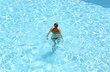 Woman swimming in the Hotel pool, Hotel la Baja, Santa Caterinia di Pittinuri, Sardinia, Italy, Europe