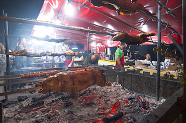 Porceddu, roast baby pork wrapped around a spit, Cordula made up of braided and cooked kid or lamb intestines wrapped around a spit, typical Sardinia recipe, Campidano, Sardinia, Italy, Europe