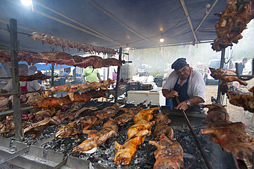 Porceddu, roast baby pork wrapped around a spit, Cordula made up of braided and cooked kid or lamb intestines wrapped around a spit, typical Sardinia recipe, Campidano, Sardinia, Italy, Europe