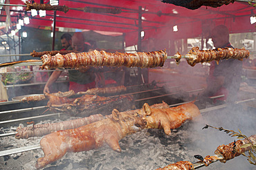 Porceddu, roast baby pork wrapped around a spit, Cordula made up of braided and cooked kid or lamb intestines wrapped around a spit, typical Sardinia recipe, Campidano, Sardinia, Italy, Europe