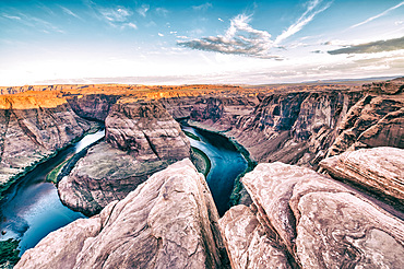 Dawn at Horseshoe Bend. Sunrise colors with Rocks and Colorado River.