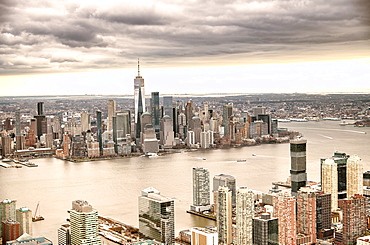 New York City from helicopter point of view. Downtown Manhattan, Jersey City and Hudson River on a cloudy day.