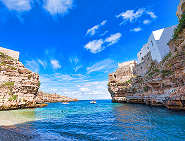 Amazing coastline of Polignano a Mare, Italy. Beach and beautiful summer sky.