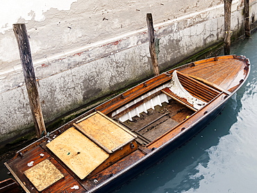 A small boat moored along the canal near the Hotel Ca Maria Adele, Venice, Veneto, Italy, Europe