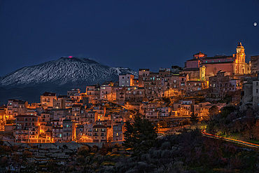 Cityscape of Centuripe and in the background the erupting Volcano Etna, Sicily, Italy, Europe