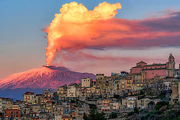 Cityscape of Centuripe and in the background the erupting Volcano Etna, Sicily, Italy, Europe