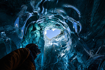 Explorer in the blue ice caves in Jˆkuls·rlÛn glacier, Iceland, North Atlantic Ocean