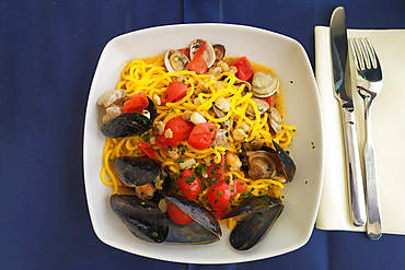 Chitarrine traditional handmade pasta with seafood and fresh tomatoes, Marche, Italy, Europe