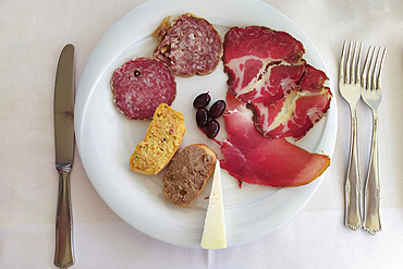 Mixed appetizer of traditional cured salami, cheese, pate and croutons, from Marche, Italy, Europe