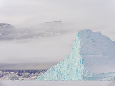 Icebergs in front of Stoeren Island, frozen into the sea ice of the Uummannaq fjord system during winter in the the north west of Greenland, far beyond the polar circle. North America, Greenland, danish territory