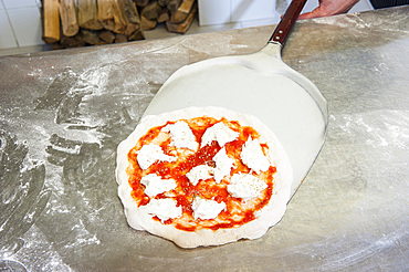 The preparation of a classic Margherita pizza, Italy, Step 10