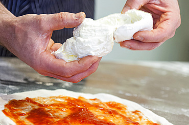 The preparation of a classic Margherita pizza, Italy, Step 12